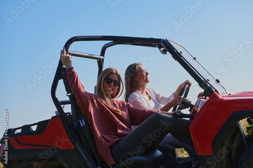 girls enjoying a beautiful sunny day while driving an off-road car