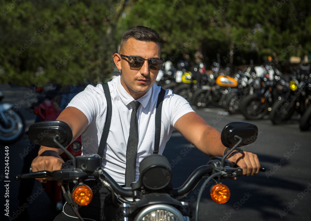 A man in vintage clothing on a motorcycle