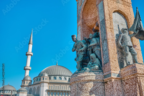 Turkey istanbul 04.03.2021. Most well known taksim square during morning with details of taksim, republic monument (cumhuriyet ant) and recently constructed taksim mosque and many turkish flags. photo