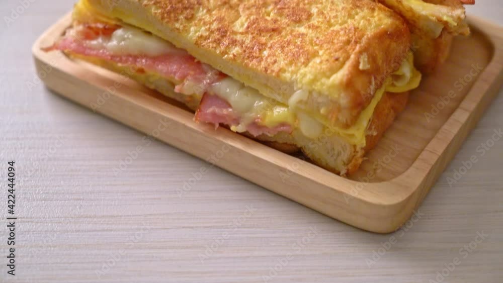 Homemade French toast ham bacon cheese sandwich with egg Homemade French toast ham bacon cheese sandwich with egg