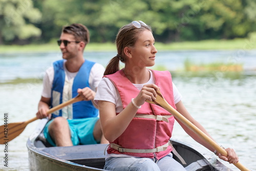 friends are canoeing in a wild river © .shock