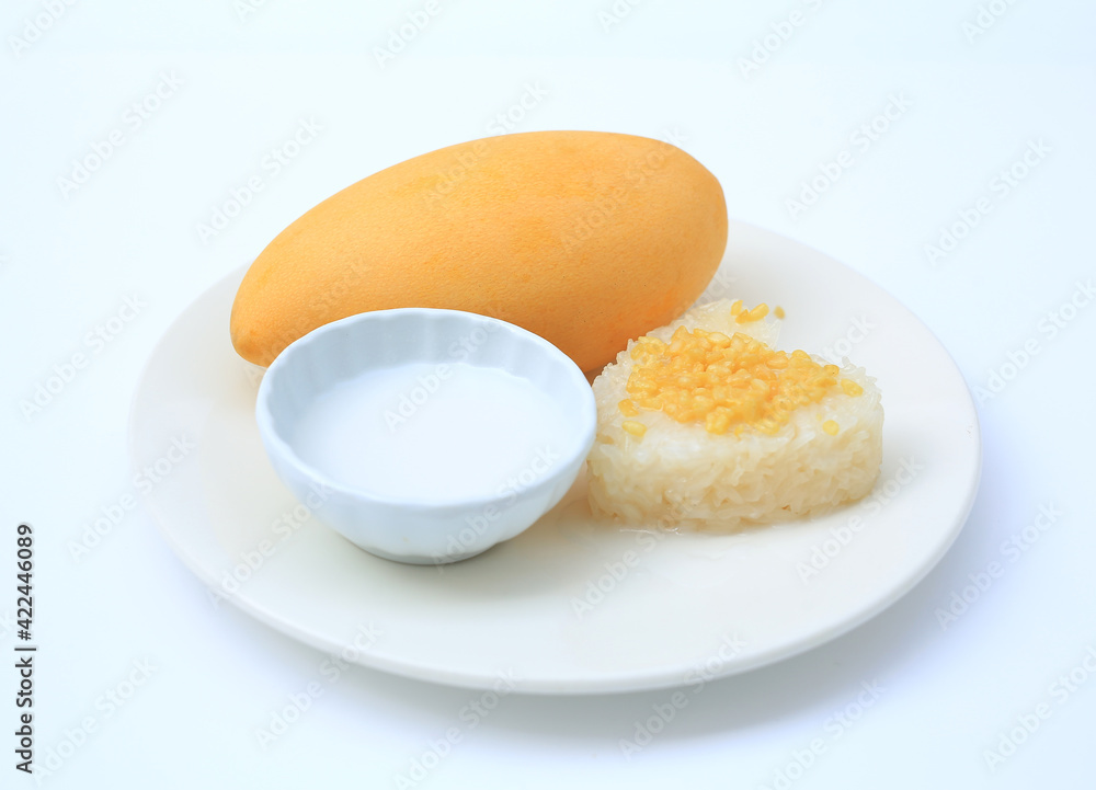Sweet ripe golden mango and sticky with coconut cream on white circle ceramic plate isolated on white background Sweet ripe golden mango and sticky with coconut cream on white circle ceramic plate isolated on white background
