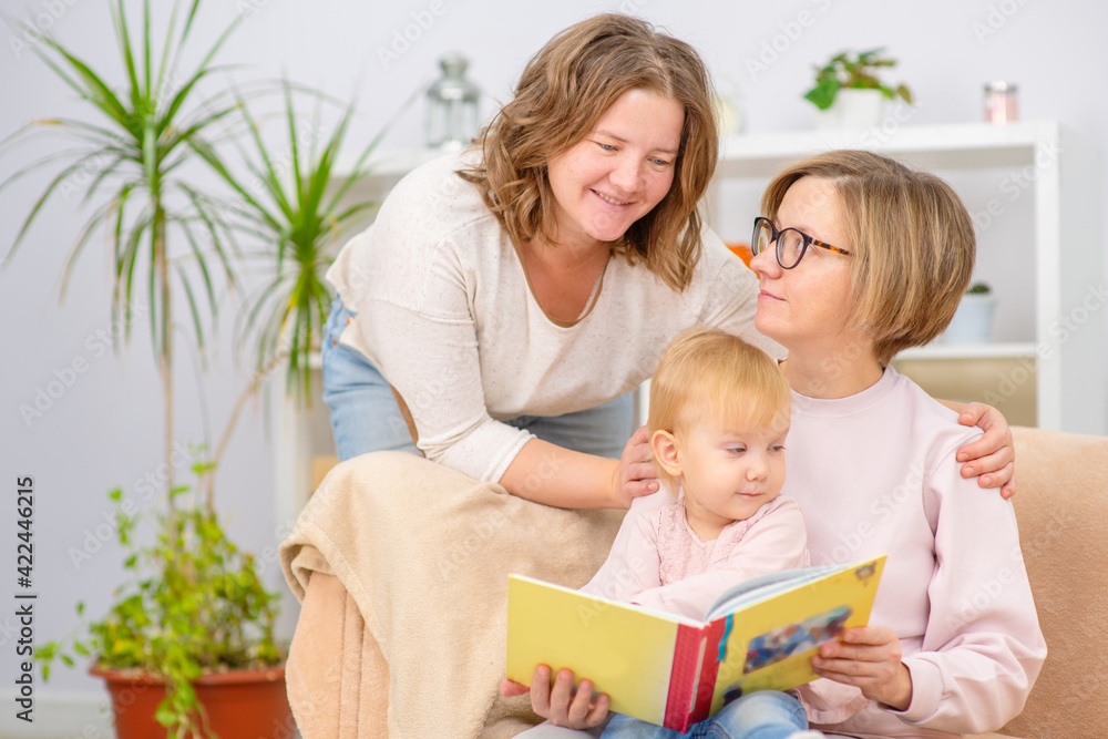 Happy daughter and smiling gay mothers in family home. Gay lesbian couple at home. Lesbian couple concept Happy daughter and smiling gay mothers in family home. Gay lesbian couple at home. Lesbian couple concept