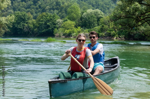 friends are canoeing in a wild river