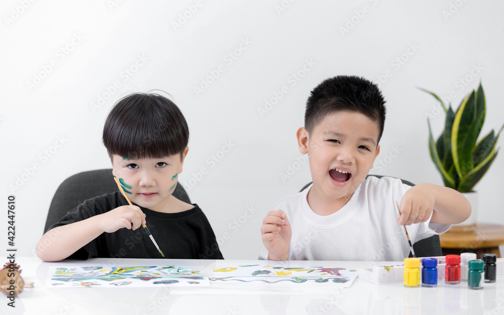 Happy two little Asian kid at the table draw with watercolor Learning and education of kid. Happy two little Asian kid at the table draw with watercolor Learning and education of kid.