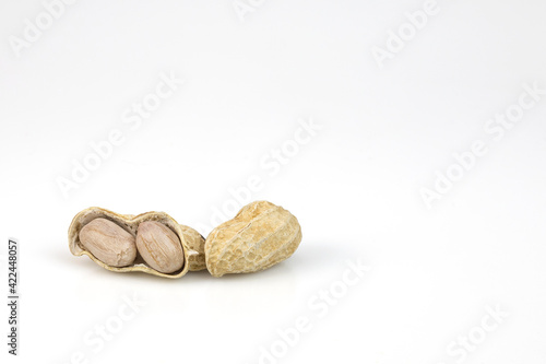 Dried peanuts in closeup isolated on white background with clipping paths.