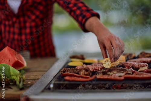 man cooking tasty food for french dinner party