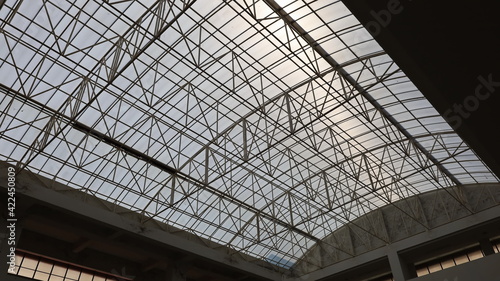 Metal building roof structures. The steel tubular structure of the transparent roof top of the building is hard to get into the bottom view. Selective focus