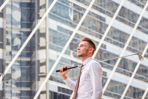 Wallpaper Mural Young business man with golf clubs in hand standing and looking into sky, Success and think big concepts Torontodigital.ca