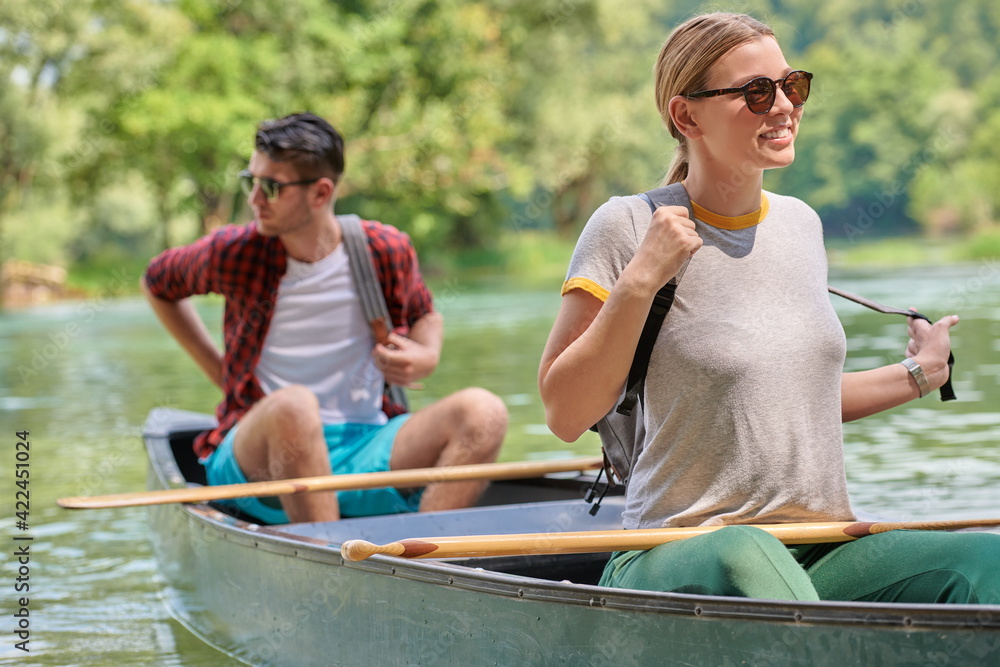 friends are canoeing in a wild river friends are canoeing in a wild river