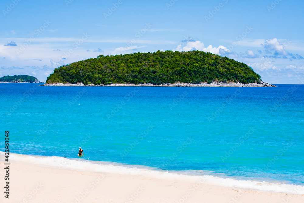 White Sand of Yanui Beach with Koh Man Island Background and Turquoise Andaman Sea in Summer, Phuket, Thailand