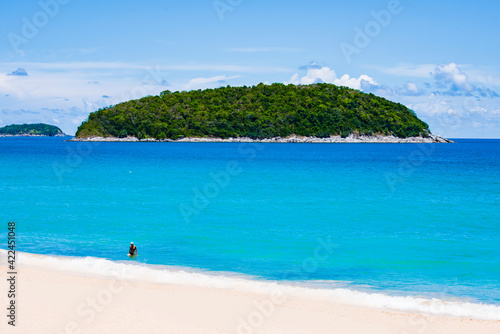 White Sand of Yanui Beach with Koh Man Island Background and Turquoise Andaman Sea in Summer, Phuket, Thailand