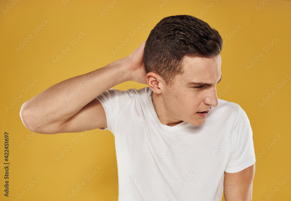 Angry man on a yellow background cry of emotion and stress Angry man on a yellow background cry of emotion and stress