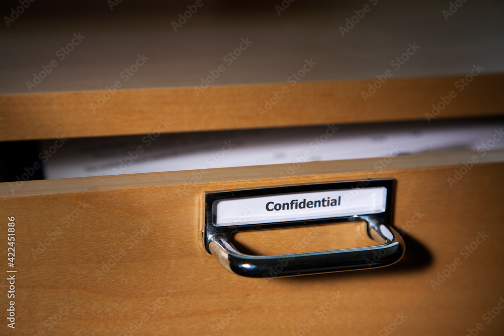 Confidential drawer open showing document inside Confidential drawer open showing document inside