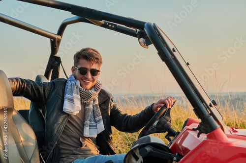 man enjoying beautiful sunny day while driving a off road buggy car