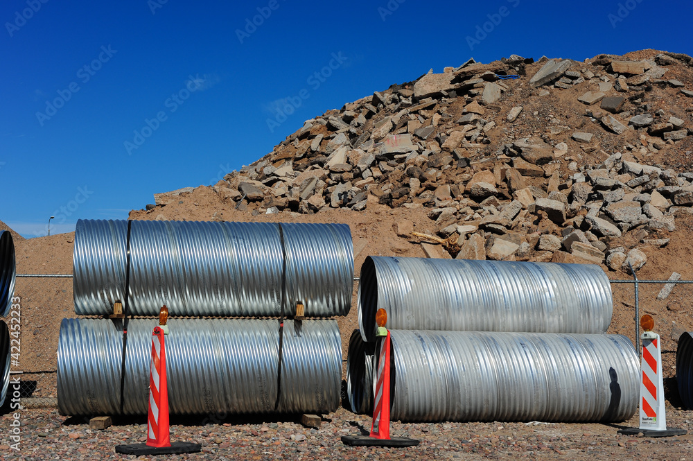 Corrugated culvert pipes at site of construction waste disposal Corrugated culvert pipes at site of construction waste disposal