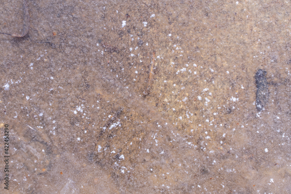the puddle is covered with ice. ice texture