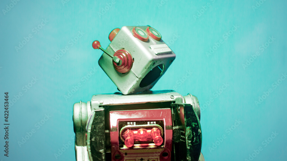 retro robot looking up blue background