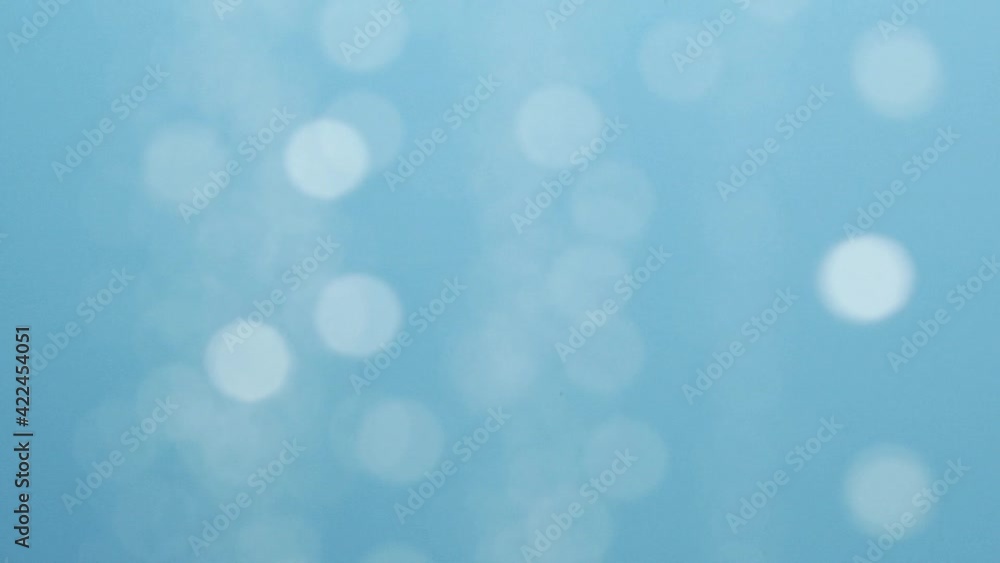 Blurred moving abstract white color light particles, blue background, lens flare Blurred moving abstract white color light particles, blue background, lens flare