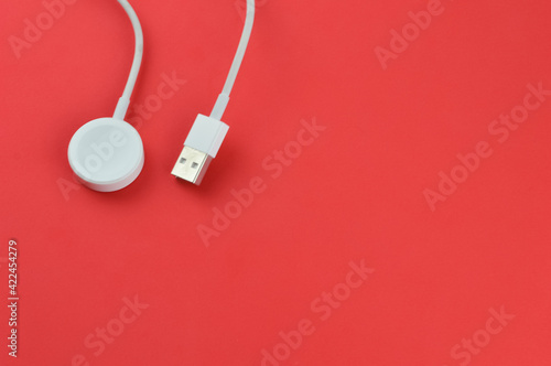 Klang,Malaysia: March 23rd 2021-Apple watch charger over red background