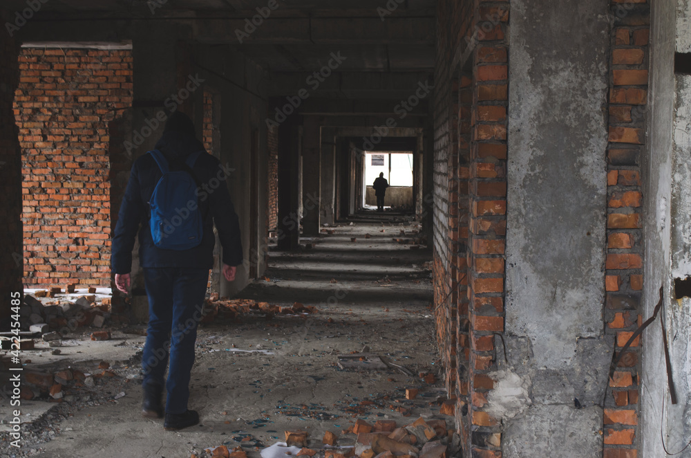 guy stalker in an abandoned ruined building