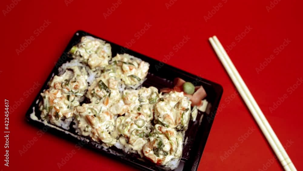 Take out Sushi Volcano Roll on a plastic container Take out Sushi Volcano Roll on a plastic container