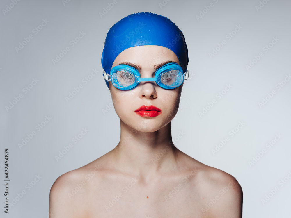 Woman in glasses and in a blue swimming cap athlete athletics model naked shoulders