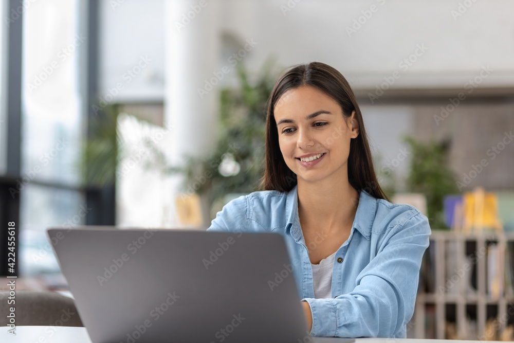 Busy caucasian young woman is sitting at the desk while remote work from home Busy caucasian young woman is sitting at the desk while remote work from home