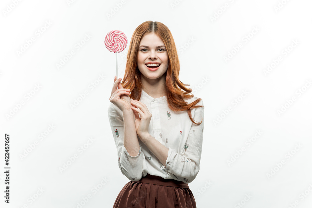 pretty red-haired woman with multicolored lollipops in her hands joy pretty red-haired woman with multicolored lollipops in her hands joy