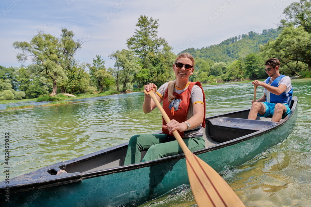 friends are canoeing in a wild river