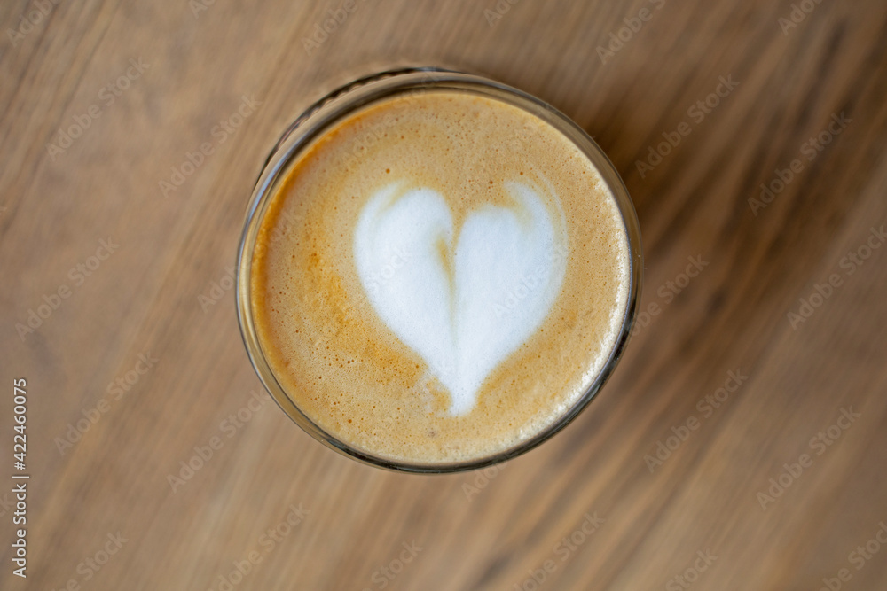 glass cup with hot coffee on the table and froth, glass cup with hot coffee on the table and froth,