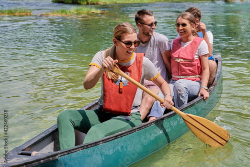 Group adventurous explorer friends are canoeing in a wild river