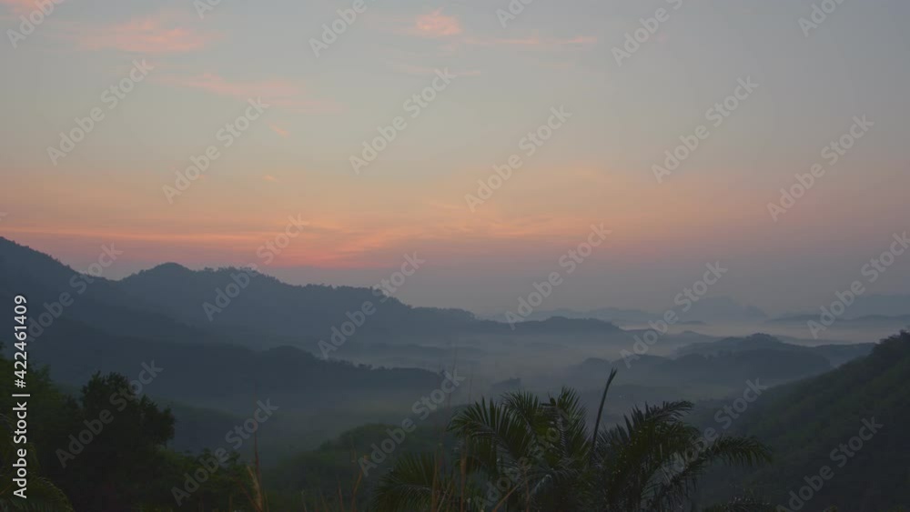 The red sky in the morning covers the misty valleys. .Phang Nga Province has many large and small hills. And wet weather in the morning often creates a sea of mist.. The red sky in the morning covers the misty valleys. .Phang Nga Province has many large and small hills. And wet weather in the morning often creates a sea of mist..