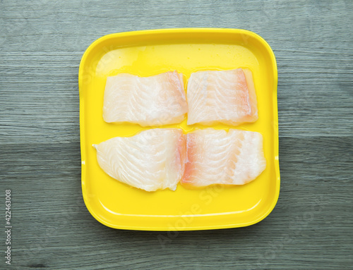 fresh raw Dolly fish sliced on square plate  on wood, wooden background,set shabu, hot pot ingredients.