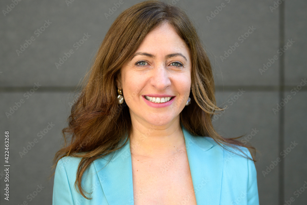 Attractive stylish middle-aged woman with a friendly smile Attractive stylish middle-aged woman with a friendly smile
