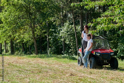 couple enjoying beautiful sunny day while driving a off road buggy © .shock