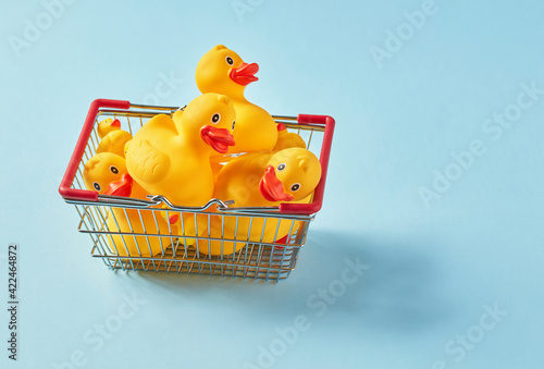 Fotografie Shopping basket full with rubber ducks
