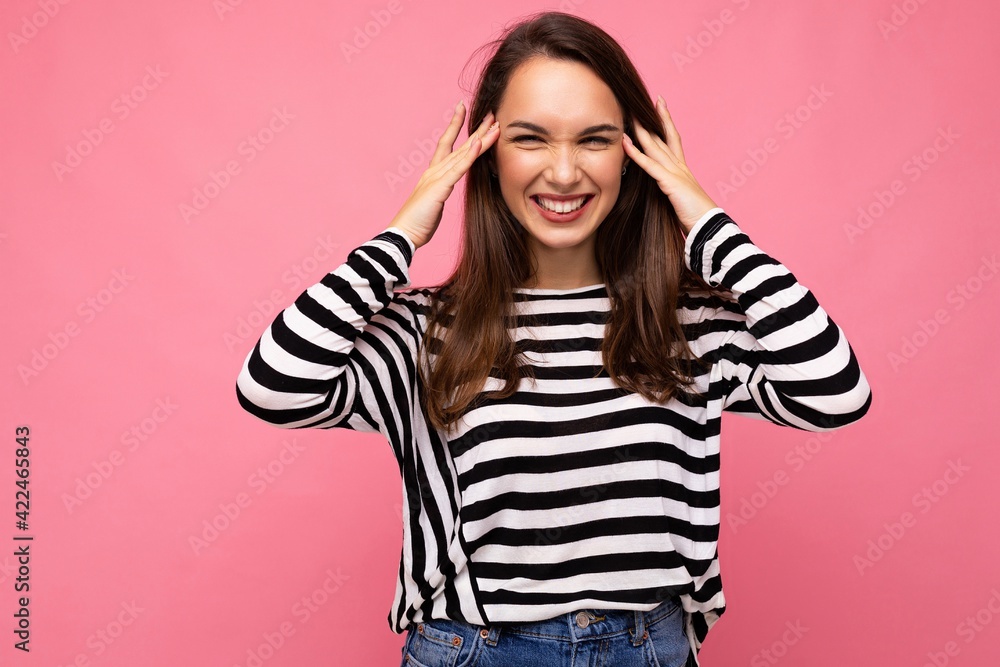 Photo of young positive happy smiling beautiful brunette woman with sincere emotions wearing casual striped pullover isolated on pink background with copy space Photo of young positive happy smiling beautiful brunette woman with sincere emotions wearing casual striped pullover isolated on pink background with copy space