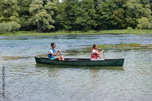 friends are canoeing in a wild river