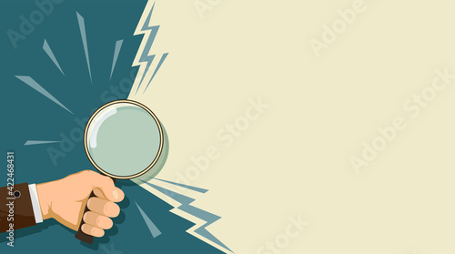Man holding a magnifying glass in his hand