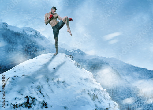 Kickboxer training on mountain top in the winter