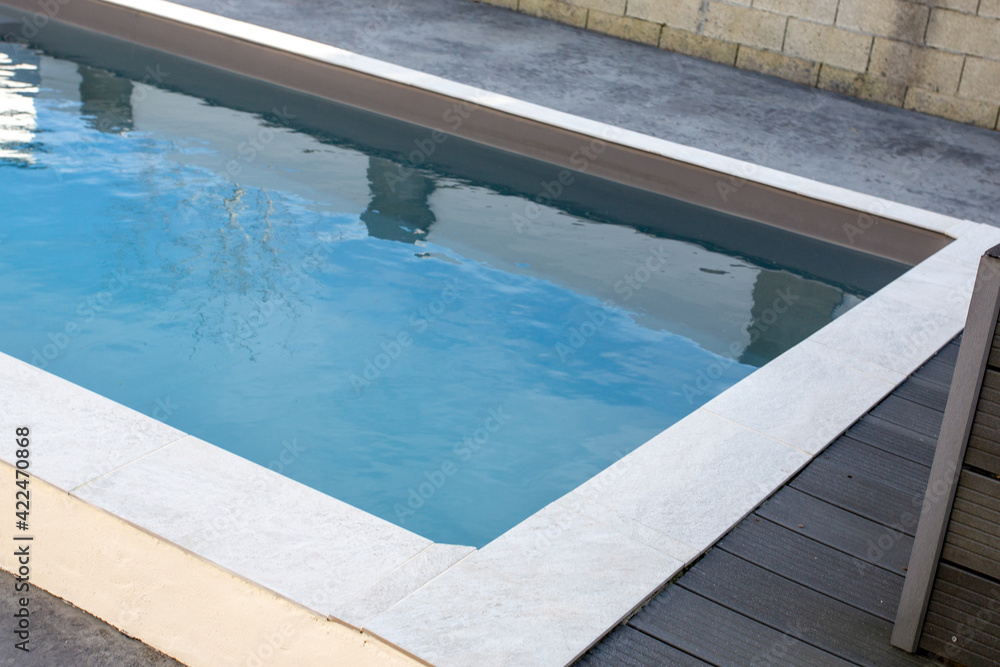 Detail of modern outdoor swimming pool in home garden