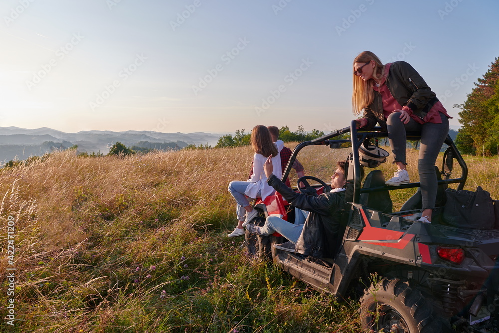 group young happy people enjoying beautiful sunny day while driving a off road buggy car group young happy people enjoying beautiful sunny day while driving a off road buggy car