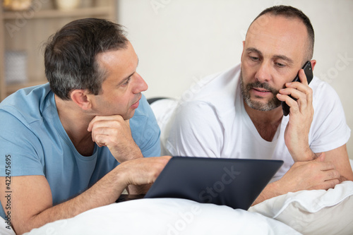 gay couple together calculate home budget