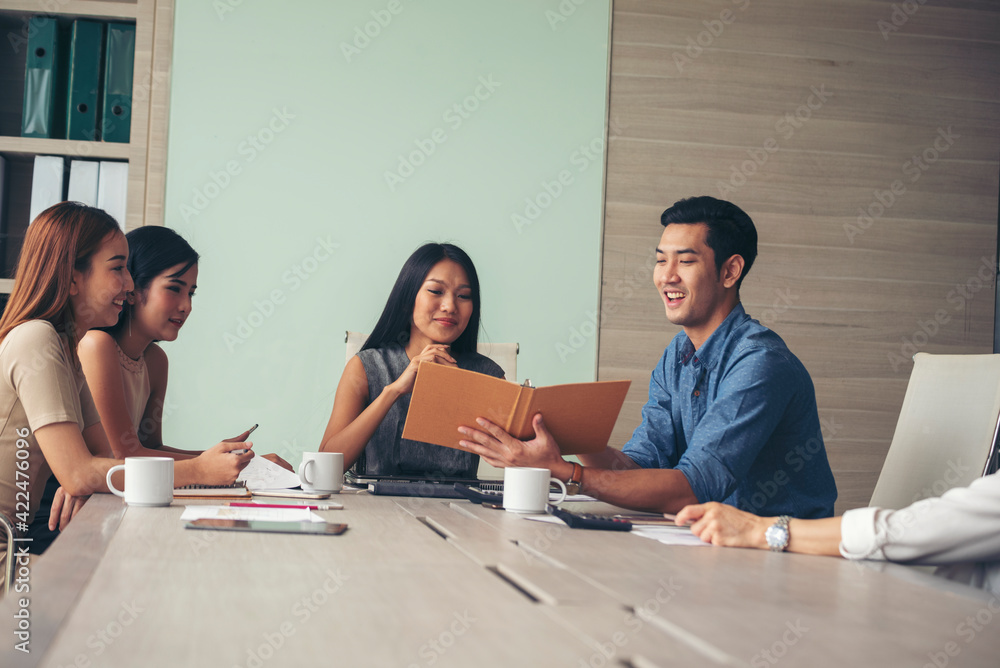 Fototapeta premium Happiness diversity business team meeting corporate office desk in company meeting room. Asian team group partner brainstorming discussion multiethnic people sitting share ideas teamwork in boardroom