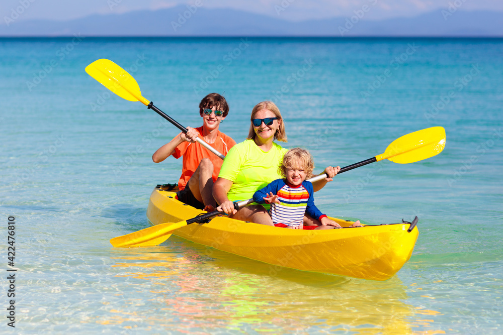 Kids kayaking in ocean. Family in kayak in tropical sea