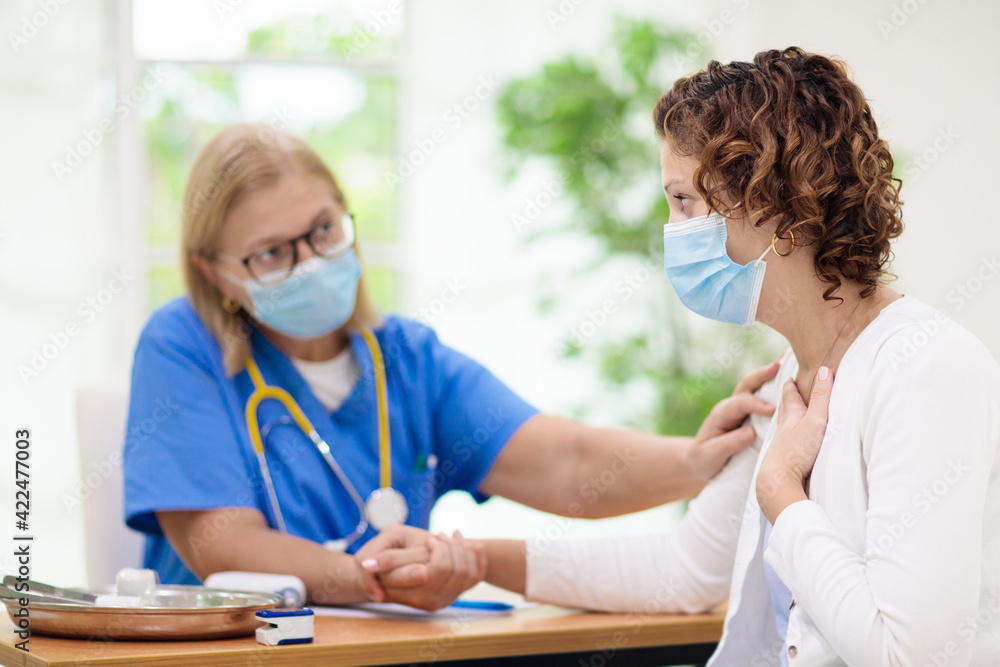 Doctor examining sick patient. Ill woman in clinic Doctor examining sick patient. Ill woman in clinic