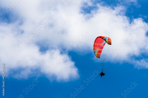 Paragliding extreme Sport with blue Sky and clouds on background Healthy Lifestyle and Freedom concept