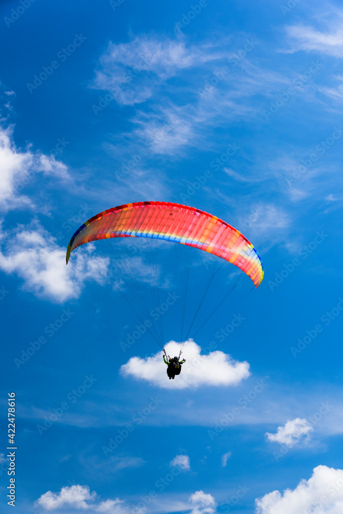 Paragliding extreme Sport with blue Sky and clouds on background Healthy Lifestyle and Freedom concept Paragliding extreme Sport with blue Sky and clouds on background Healthy Lifestyle and Freedom concept