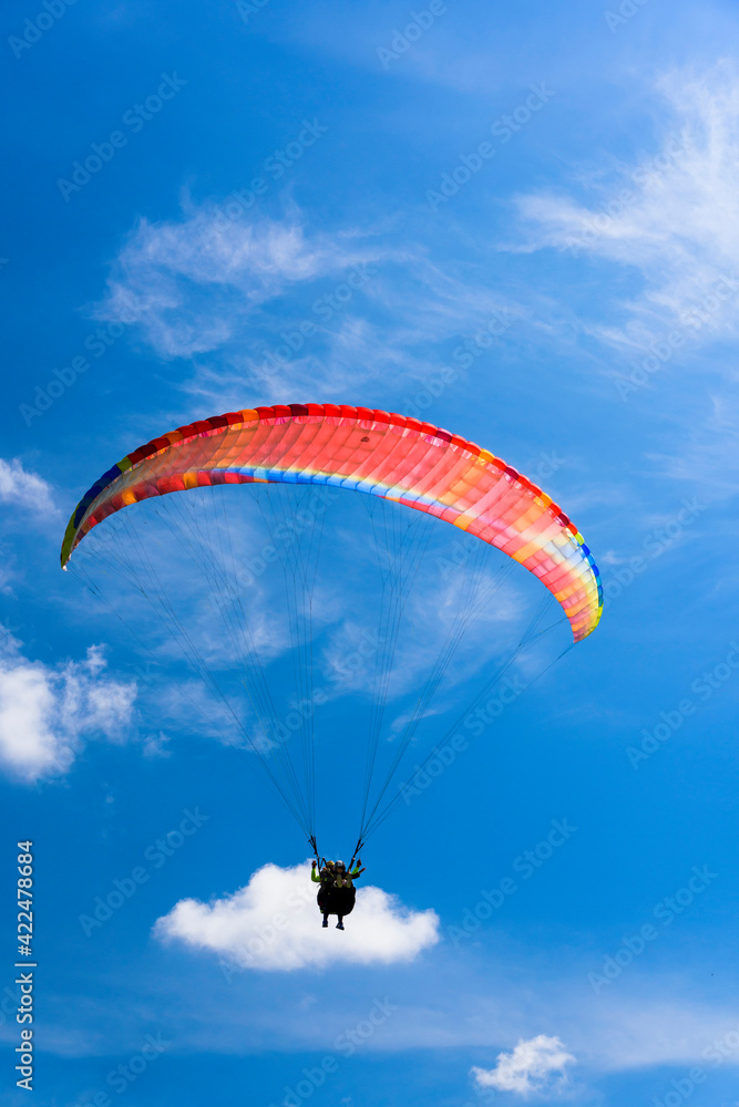 Paragliding extreme Sport with blue Sky and clouds on background Healthy Lifestyle and Freedom concept Paragliding extreme Sport with blue Sky and clouds on background Healthy Lifestyle and Freedom concept